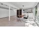 A modern living room with unique furniture arrangement and bright natural light, perfect for both relaxation and entertainment at 1677 Hyde Park St, Sarasota, FL 34239
