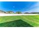 Expansive backyard featuring lush green grass and a white fence with neighboring homes at 1721 Palm Warbler Ln, Ruskin, FL 33570