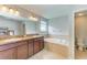 Bathroom with double vanity, a soaking tub, and tiled floors at 1721 Palm Warbler Ln, Ruskin, FL 33570