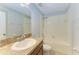Bathroom featuring a vanity with granite countertop, mirror, and a shower-tub combo at 1721 Palm Warbler Ln, Ruskin, FL 33570