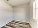 Small bedroom featuring neutral walls, and wood-look floors at 1721 Palm Warbler Ln, Ruskin, FL 33570