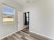 Bedroom featuring gray wood floors, a window, and a closet at 1721 Palm Warbler Ln, Ruskin, FL 33570