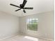 This is a cozy bedroom with a ceiling fan, a window, and soft carpet flooring at 1721 Palm Warbler Ln, Ruskin, FL 33570