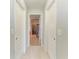 Clean hallway with access to a bathroom showcasing neutral tones and design at 1721 Palm Warbler Ln, Ruskin, FL 33570