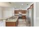 Stainless steel appliances complement granite countertops in the kitchen with recessed lights at 1721 Palm Warbler Ln, Ruskin, FL 33570