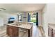 Island kitchen with hardwood style floors, stainless steel appliances, and sliding glass doors at 1721 Palm Warbler Ln, Ruskin, FL 33570