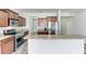 Kitchen featuring stainless steel appliances, granite countertops, and light hardwood style floors at 1721 Palm Warbler Ln, Ruskin, FL 33570