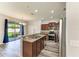 Granite countertops highlight this kitchen with stainless steel appliances and hardwood style floors at 1721 Palm Warbler Ln, Ruskin, FL 33570