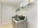Well-equipped laundry room featuring a modern washer and dryer set with tile flooring at 1721 Palm Warbler Ln, Ruskin, FL 33570