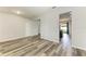 Open concept living room with hardwood style floors, white walls, and modern recessed lighting at 1721 Palm Warbler Ln, Ruskin, FL 33570