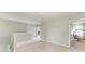Carpeted upstairs loft with a neutral color palette at 1721 Palm Warbler Ln, Ruskin, FL 33570