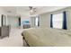 Main bedroom featuring neutral paint, carpet floors, a ceiling fan, and big windows for lots of natural light at 1721 Palm Warbler Ln, Ruskin, FL 33570