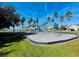 Community playground featuring swings and other play equipment, surrounded by green grass at 1721 Palm Warbler Ln, Ruskin, FL 33570