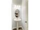 Charming powder room featuring pedestal sink, classic lighting, and neutral wall color at 1721 Palm Warbler Ln, Ruskin, FL 33570