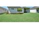 Lush backyard featuring healthy green grass and mature tropical landscaping at 17723 Palmiste Dr, Bradenton, FL 34202