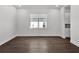 Open bedroom with dark hardwood floors and a view of a large window at 17723 Palmiste Dr, Bradenton, FL 34202