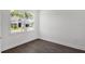 Bedroom with a window letting in natural light, complemented by hardwood floors at 17723 Palmiste Dr, Bradenton, FL 34202