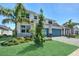 Stunning exterior of a new construction home with lush green lawn and landscaping at 17723 Palmiste Dr, Bradenton, FL 34202