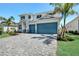 Charming two-story home with blue garage doors and a paved driveway at 17723 Palmiste Dr, Bradenton, FL 34202