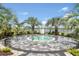 A hot tub is surrounded by a decorative stone border, mulch and palms at 17723 Palmiste Dr, Bradenton, FL 34202