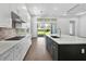 Modern kitchen featuring quartz countertops, stainless steel appliances, and an island with a sink at 17723 Palmiste Dr, Bradenton, FL 34202