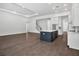 Spacious living room with dark hardwood floors, next to a modern kitchen with an island at 17723 Palmiste Dr, Bradenton, FL 34202