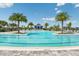 A sparkling community pool is surrounded by palm trees and lounge chairs and has a gradual zero entry at 17723 Palmiste Dr, Bradenton, FL 34202