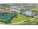 Aerial view of community amenities, including a pool, clubhouse, tennis courts, and landscaping at 17911 Palmiste Dr, Bradenton, FL 34202