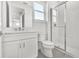 Bright bathroom featuring a vanity with modern hardware and a glass-enclosed shower at 17911 Palmiste Dr, Bradenton, FL 34202