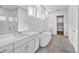 Bright bathroom featuring a soaking tub, double vanity, and walk-in shower, complemented by wood-look flooring at 17911 Palmiste Dr, Bradenton, FL 34202