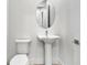 Elegant half-bathroom with pedestal sink and oval mirror at 17911 Palmiste Dr, Bradenton, FL 34202