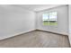 Empty bedroom featuring wood floors and a window overlooking a scenic outdoor view at 17911 Palmiste Dr, Bradenton, FL 34202