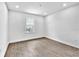 Empty bedroom featuring wood floors, a window, and white trim; ready for customization at 17911 Palmiste Dr, Bradenton, FL 34202