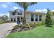 Beautifully landscaped front yard with a modern home and 'quick move-in' sign at 17911 Palmiste Dr, Bradenton, FL 34202