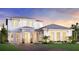 Charming two-story home with a well-maintained lawn, landscaped with shrubs and beautiful twilight skies at 17911 Palmiste Dr, Bradenton, FL 34202