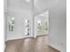 Bright foyer with hardwood floors, white walls, and an abundance of natural light at 17911 Palmiste Dr, Bradenton, FL 34202