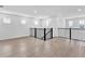 Spacious loft area with wood flooring, black railing, and multiple windows for ample natural light at 17911 Palmiste Dr, Bradenton, FL 34202