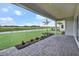Spacious, covered patio with a scenic view of the lake and backyard at 17911 Palmiste Dr, Bradenton, FL 34202