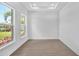 Bright room with light wood floors, two large windows, and recessed lighting at 17911 Palmiste Dr, Bradenton, FL 34202