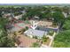 A high angle shows the property's location near tennis courts, parking, and lush green surroundings at 1869 Springbush Ln, Clearwater, FL 33763