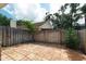 Backyard showcasing brick pavers and a wooden fence offering privacy and charm at 1869 Springbush Ln, Clearwater, FL 33763