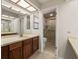 Bathroom with a large mirror, wooden cabinets, and a view of a shower area at 1869 Springbush Ln, Clearwater, FL 33763