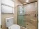 Well-lit bathroom showcases a glass door shower and a modern toilet at 1869 Springbush Ln, Clearwater, FL 33763
