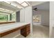 Bathroom vanity area leading to another room with a sliding glass door to the backyard at 1869 Springbush Ln, Clearwater, FL 33763