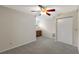 Cozy carpeted bedroom featuring a ceiling fan, closet, and wet bar for added convenience at 1869 Springbush Ln, Clearwater, FL 33763