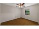 Bright bedroom with wood flooring, ceiling fan, and a window offering natural light at 1869 Springbush Ln, Clearwater, FL 33763