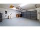 Attached garage with updated lighting, pegboard wall, work bench and ample storage at 1869 Springbush Ln, Clearwater, FL 33763