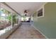 Inviting screened lanai with tile flooring, ceiling fans, and backyard views at 1869 Springbush Ln, Clearwater, FL 33763