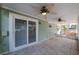 Screened lanai with ceiling fans, tile flooring, and access to the outdoors at 1869 Springbush Ln, Clearwater, FL 33763