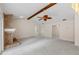 Spacious living room with a fireplace, carpeted flooring, and exposed beam ceiling at 1869 Springbush Ln, Clearwater, FL 33763